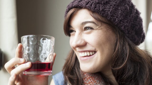 young woman drinking cranberry juice
