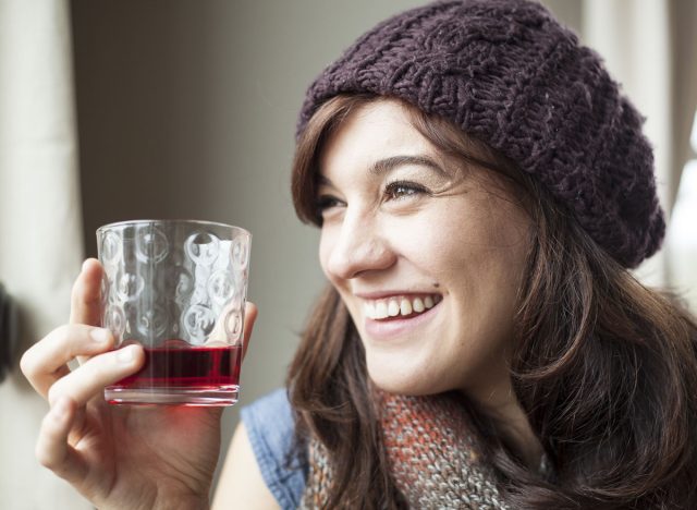 young woman drinking cranberry juice