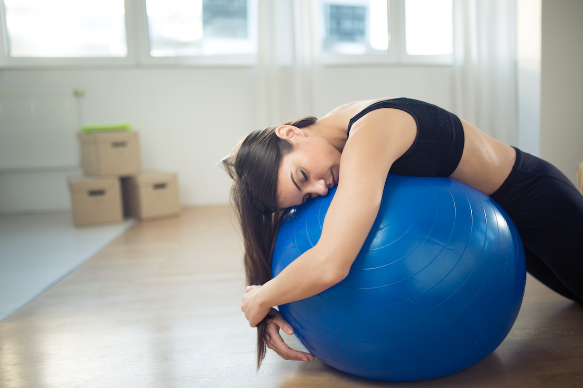 Disappointed,Fitness,Woman,Sitting,On,Fitness,Pilates,Ball,In,Room