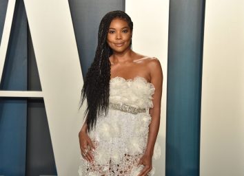 gabrielle union in white lace and ruffled dress on vanity fair red carpet