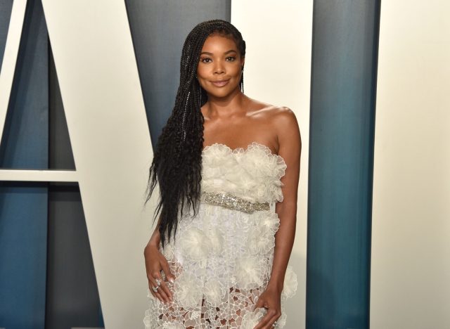 gabrielle union in white lace and ruffled dress on vanity fair red carpet