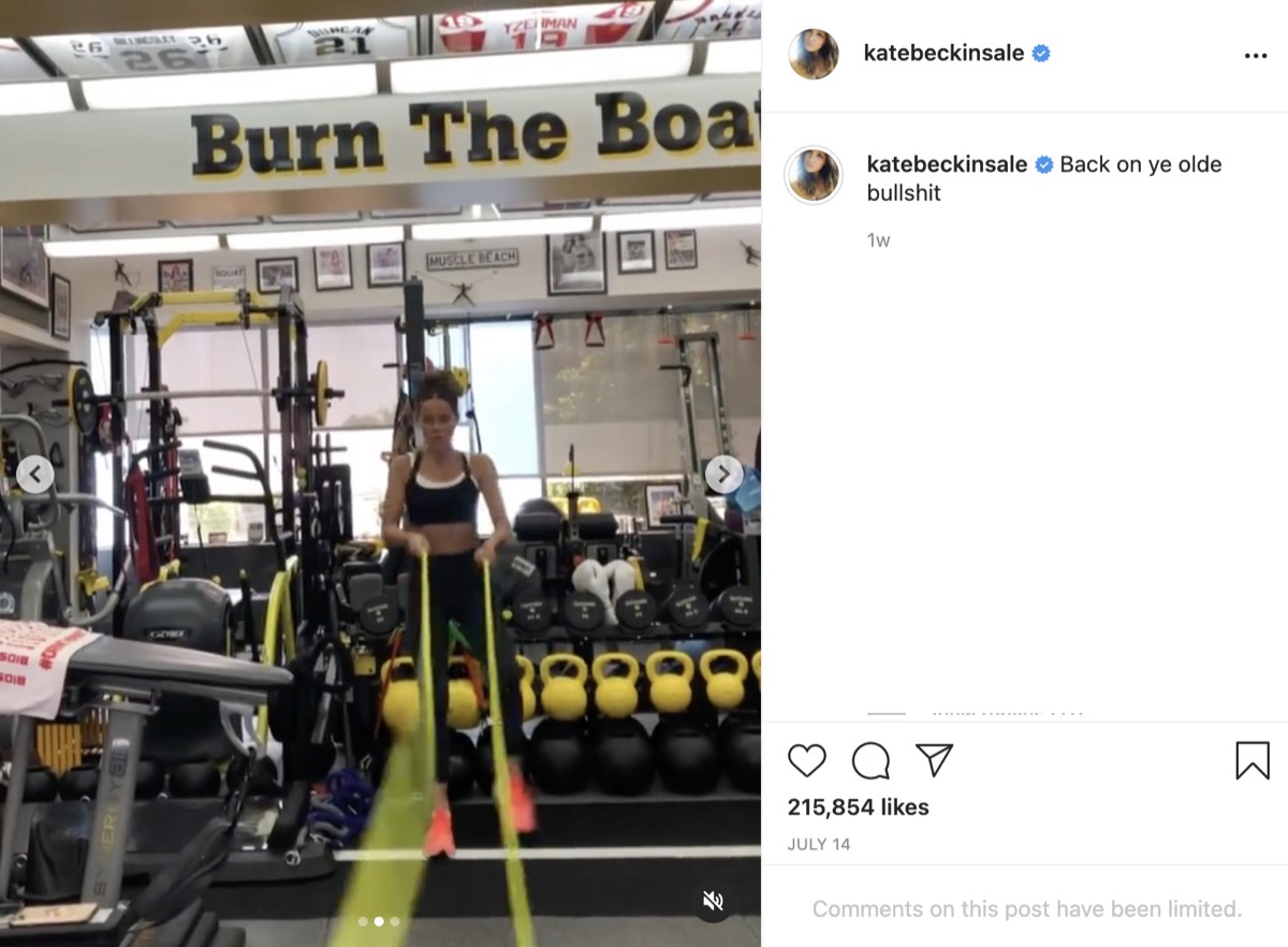 kate beckinsale doing battle rope workout in front of weight rack
