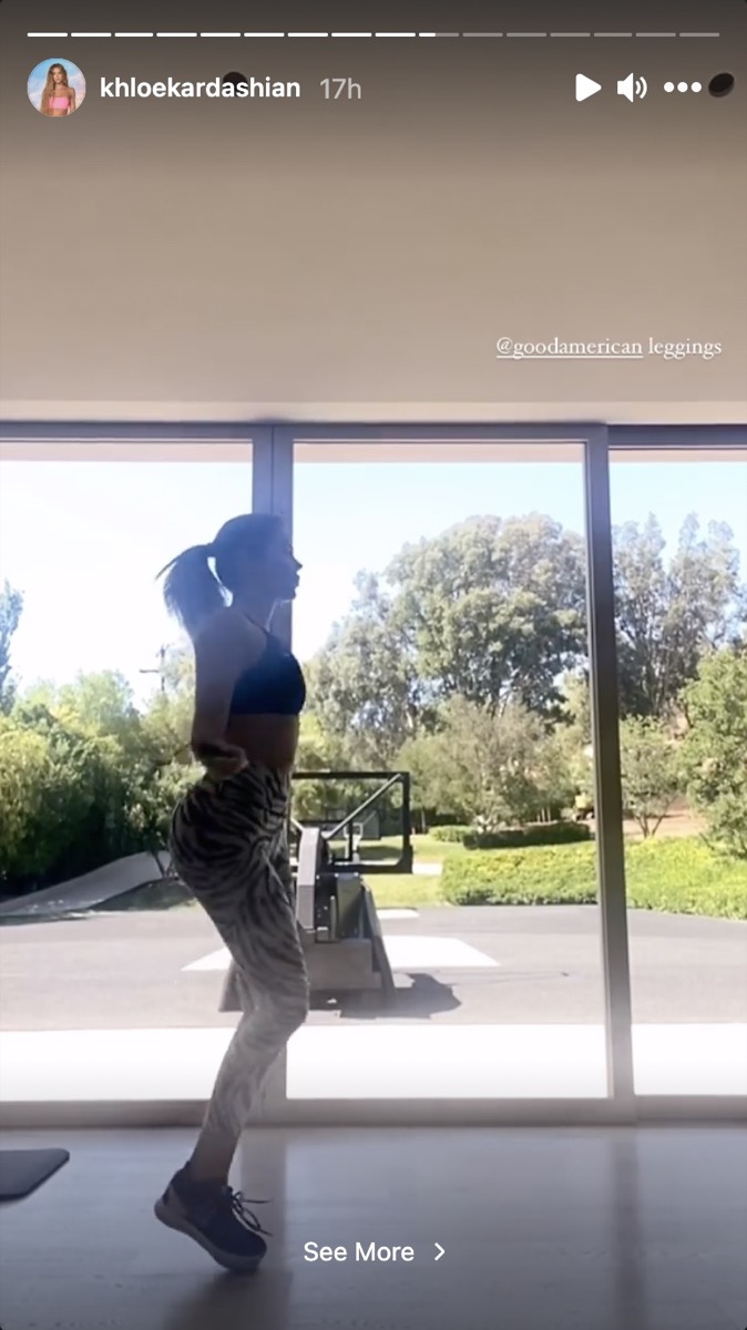 khloe kardashian in front of floor to ceiling windows in a gym jumping rope