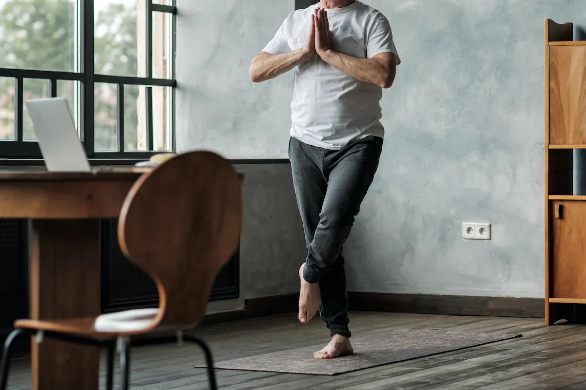 Man standing in one leg yoga balance variation. No face view. Healthy lifestyle at old age