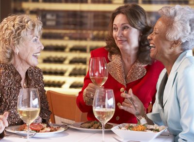 older woman eating dinner in a restaurant
