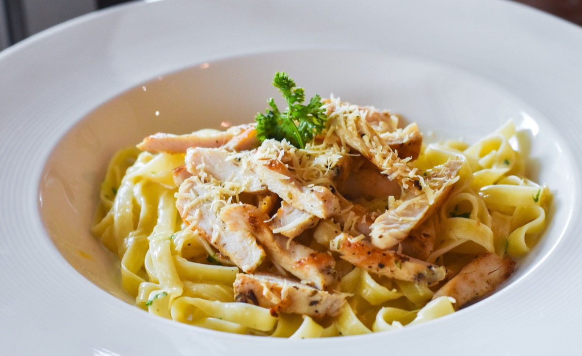 pasta with chicken in white bowl