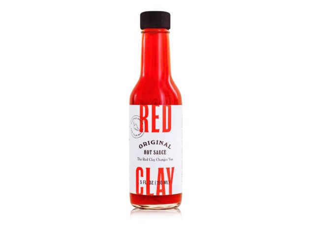 bottle of Red Clay hot sauce on a white background