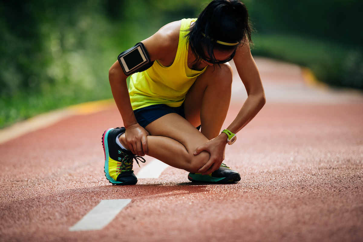 Female runner suffering with pain on sports running knee injury