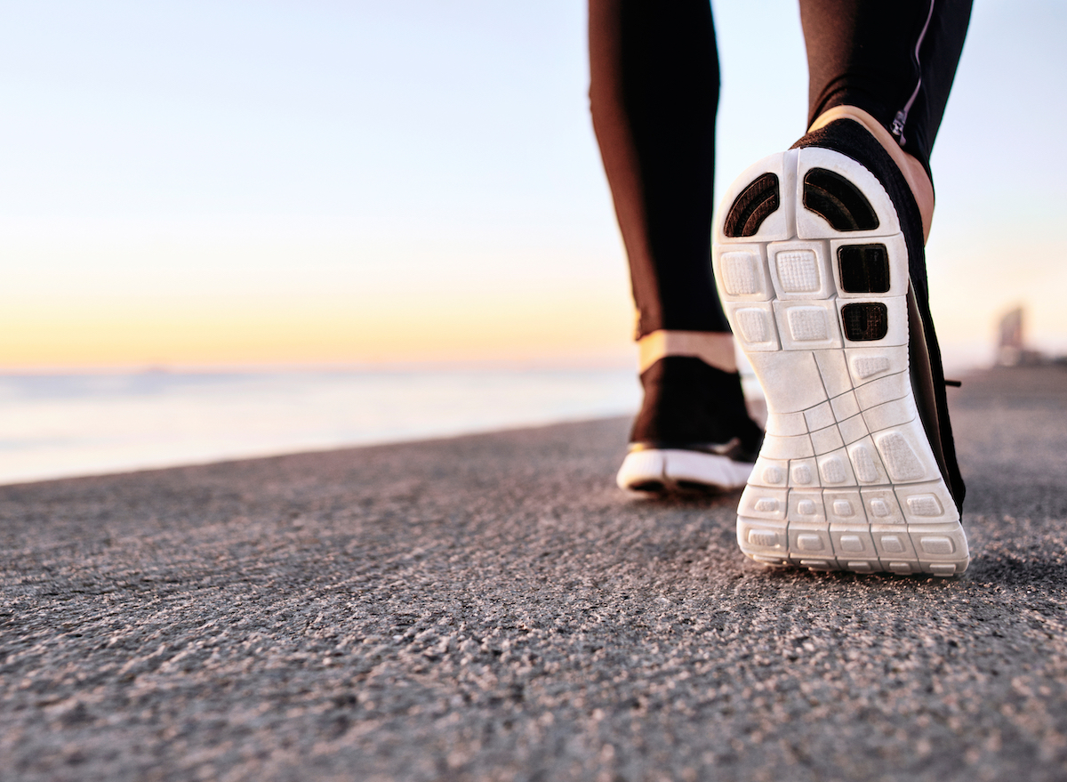 athlete-walking-on-pavement-shoe-closeup