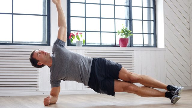 man-doing-side-planks-at-home
