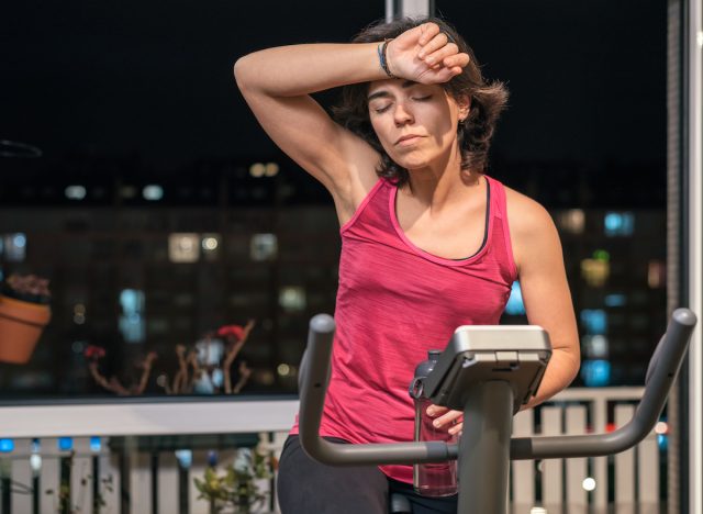 woman doing spin workout at night