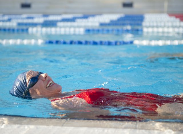 older woman swimming in pool