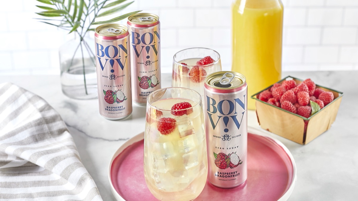 bon viv spiked seltzers on tray with glass full of seltzer and raspberries