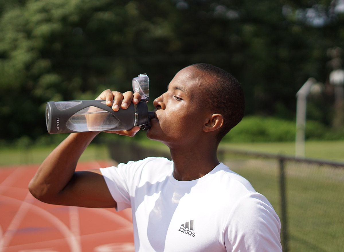 athlete drinking cold water on the track