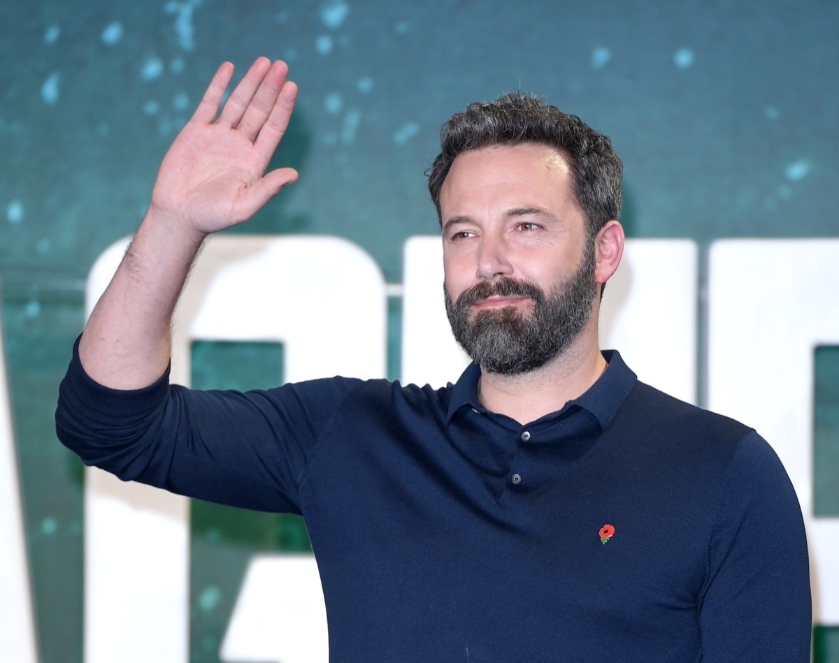 ben affleck waving on the red carpet in blue shirt