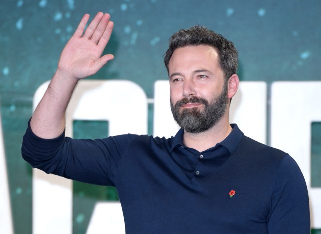 ben affleck waving on the red carpet in blue shirt