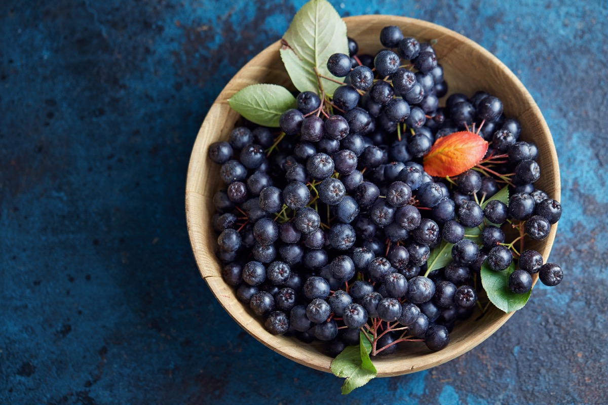 chokeberries in wooden bowl