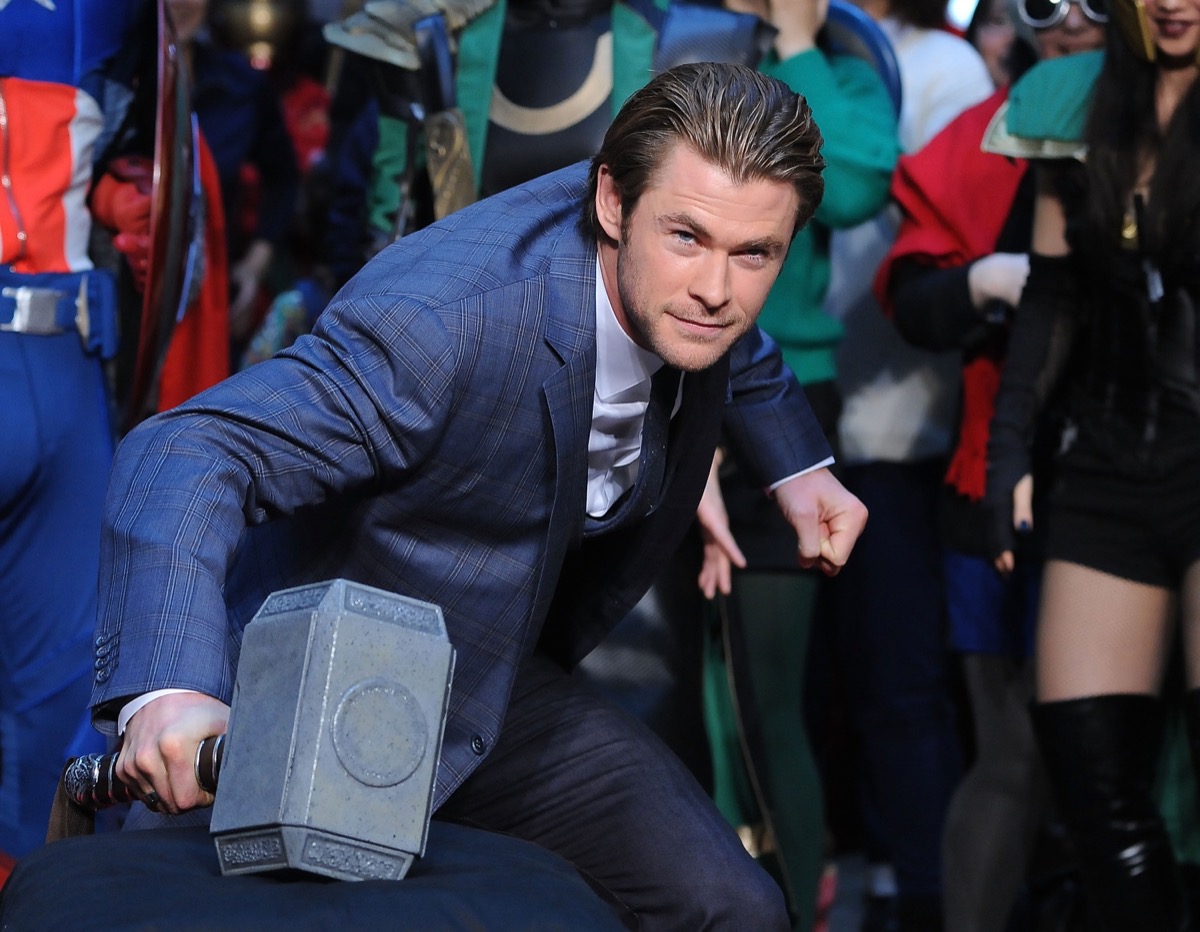 chris hemsworth posing with thor's hammer