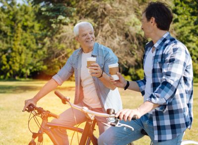 two men on bikes drinking coffee