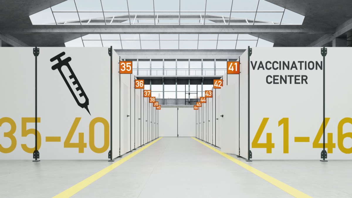 Temporary Corona vaccination center in warehouse with cabins.
