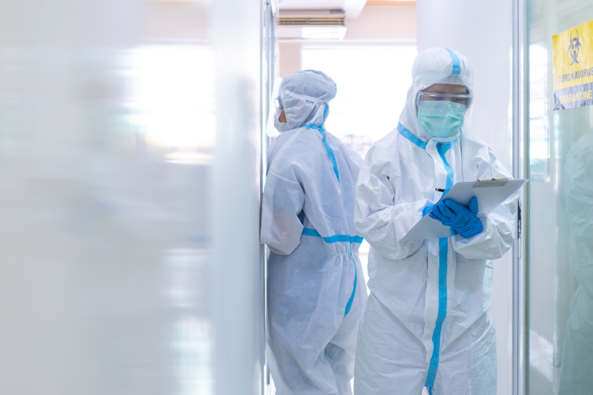 Two doctors in personal protective equipment or ppe including white suit, mask, face shield and gloves.