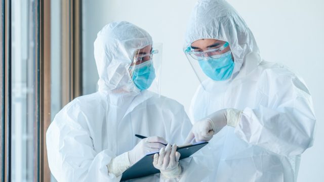 Two doctors wearing personal personal protective equipment