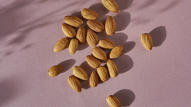 almonds on a pink table