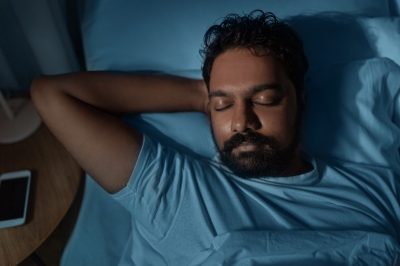 man sleeping soundly in bed