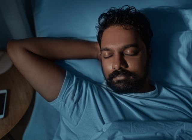 man sleeping soundly in bed