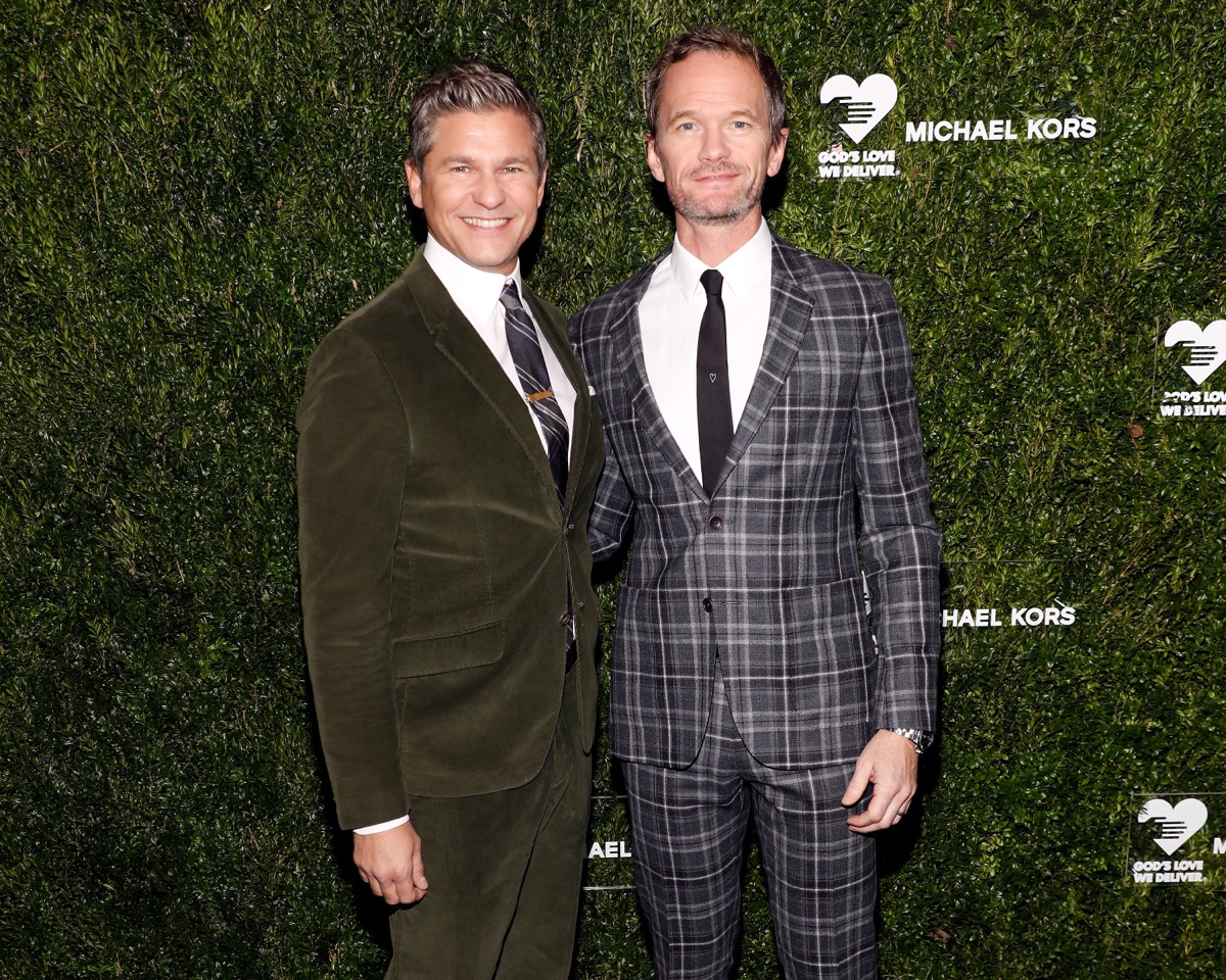 neil patrick harris in green velvet and blue plaid suits respectively in front of green living wall