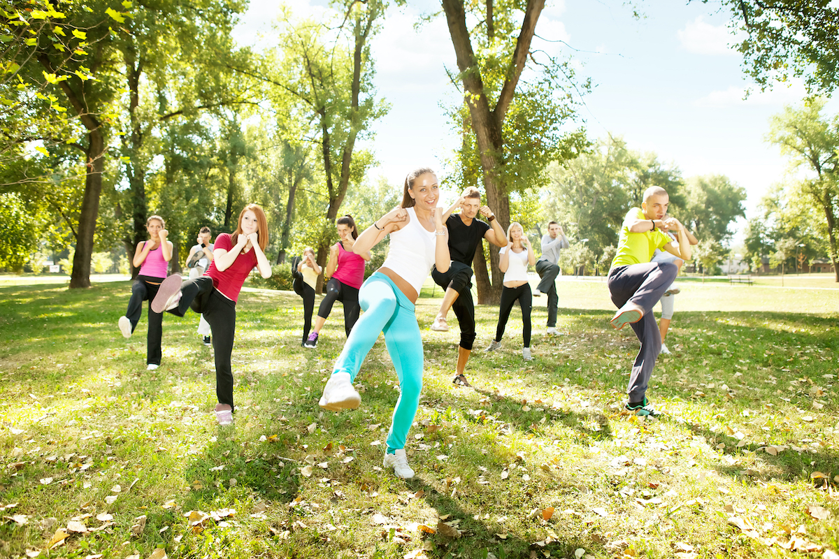 large group of young people training Tae Bo, outdoor