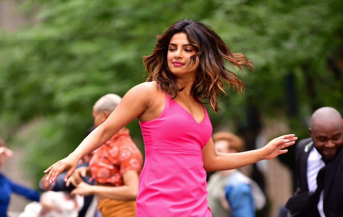 priyanka chopra dancing in pink dress on city street