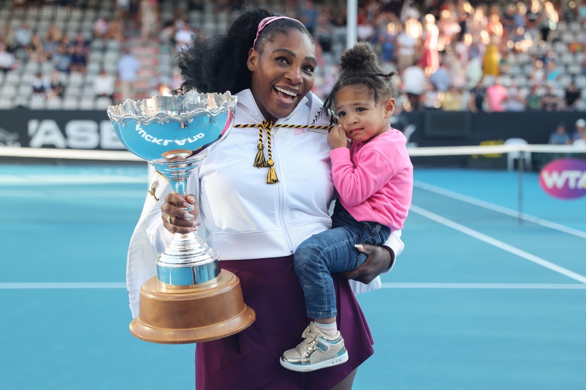 serena williams holding her daughter olympia and a trophy