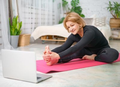 older-woman-stretching-on-yoga-mat