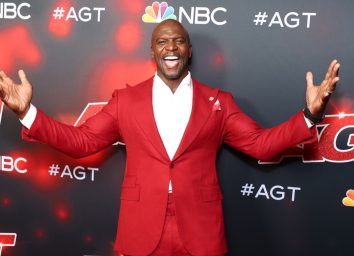 terry crews in red suit on red carpet