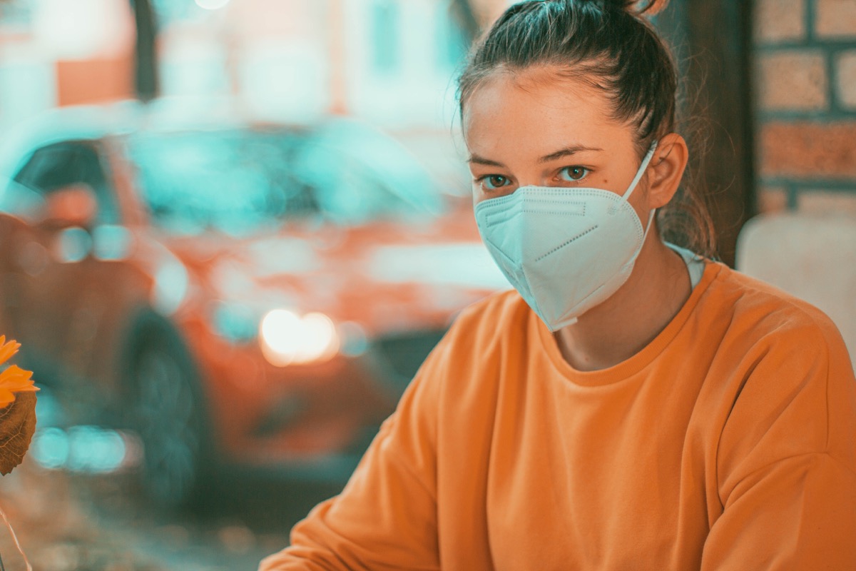 Woman in restaurant with face protection mask kn95.