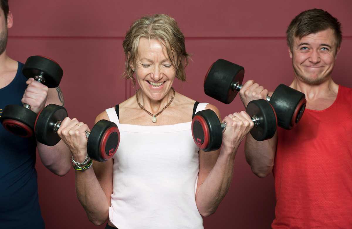 Older people lifting weights in gym