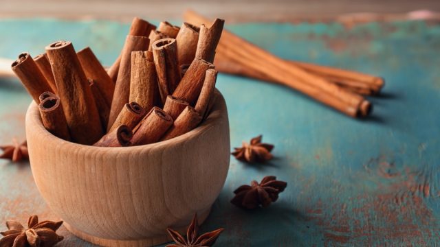 wooden bowl full of cinnamon sticks