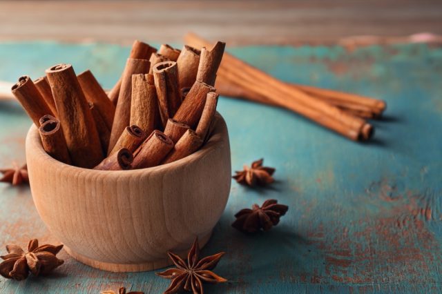 wooden bowl full of cinnamon sticks