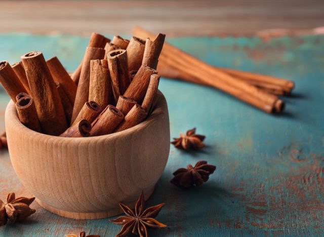 wooden bowl full of cinnamon sticks