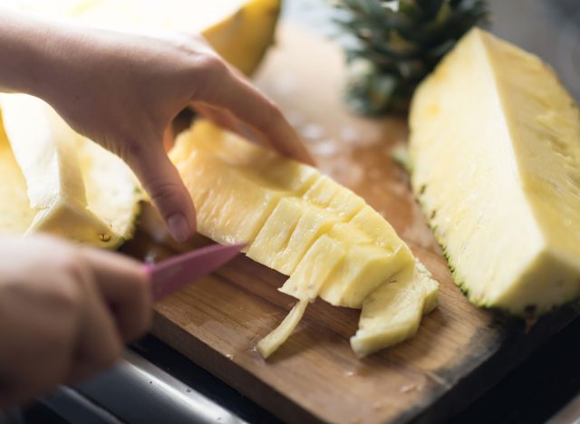 cutting pineapple