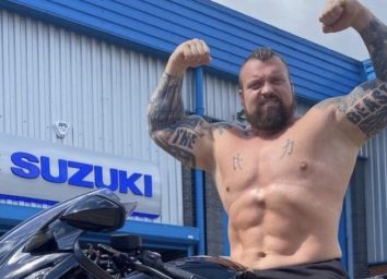 eddie hall sitting on a motorcycle