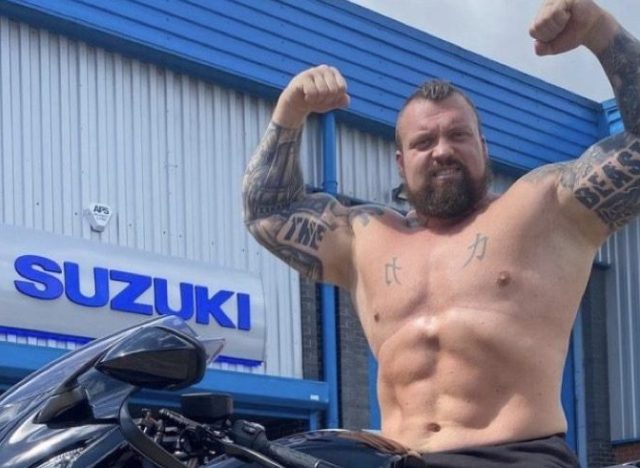 eddie hall sitting on a motorcycle