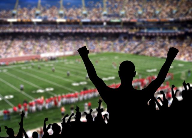 Fan celebrating a victory at a American football game.