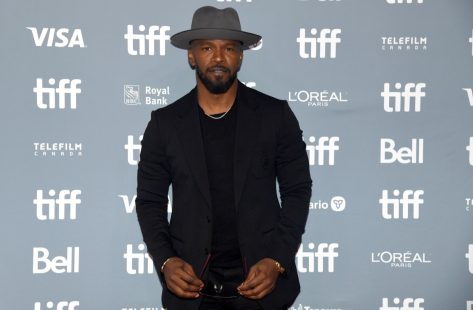 jamie foxx in black suit and gray hat on red carpet at toronto international film festival