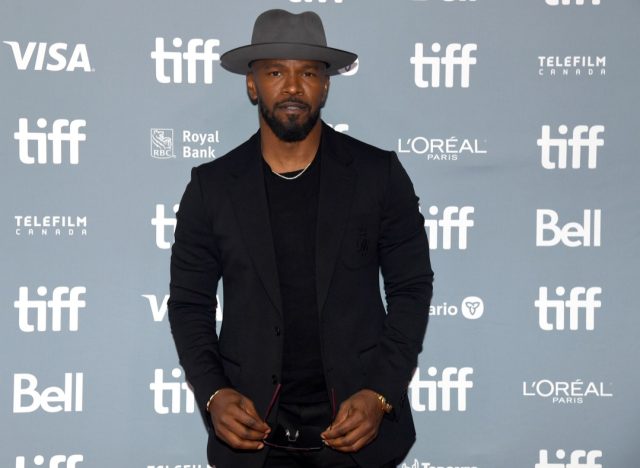jamie foxx in black suit and gray hat on red carpet at toronto international film festival