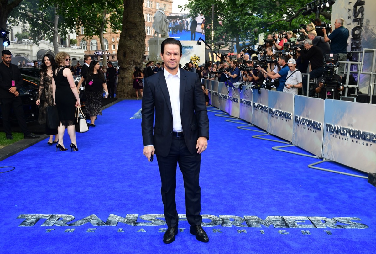 mark wahlberg in black suit on blue carpet at transformers premiere