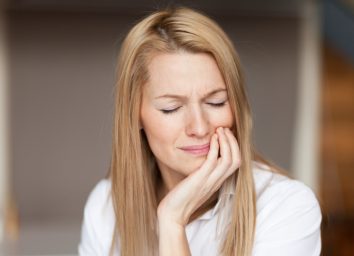 Mature woman feeling strong pain, toothache.