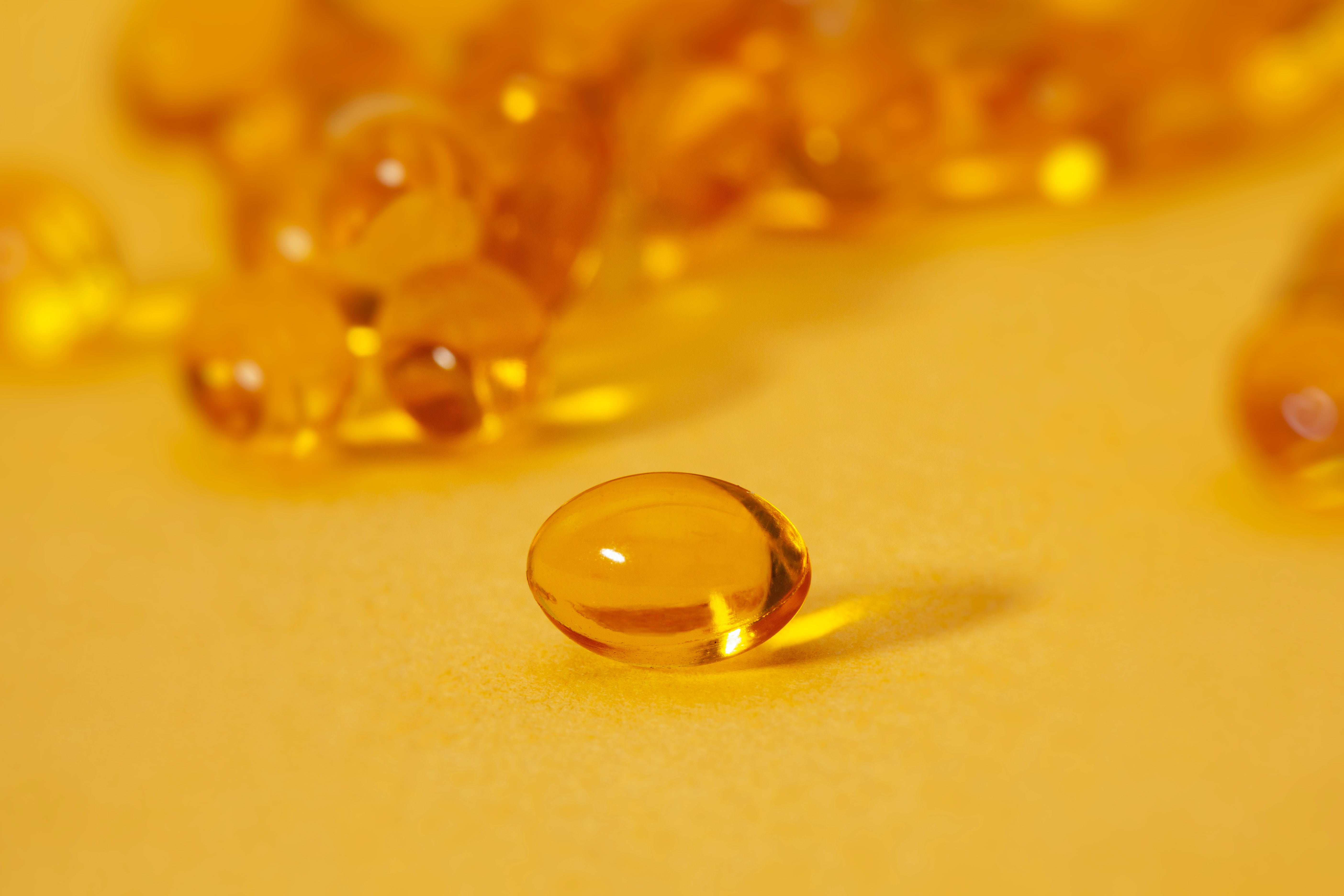 vitamin d supplements on a yellow table