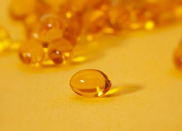 vitamin d supplements on a yellow table